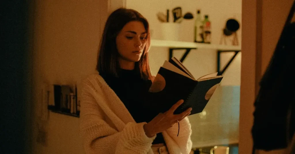 Best 12 Dark Feminine Energy Books To Unleash Your Power 11 woman reading a dark feminine energy book
